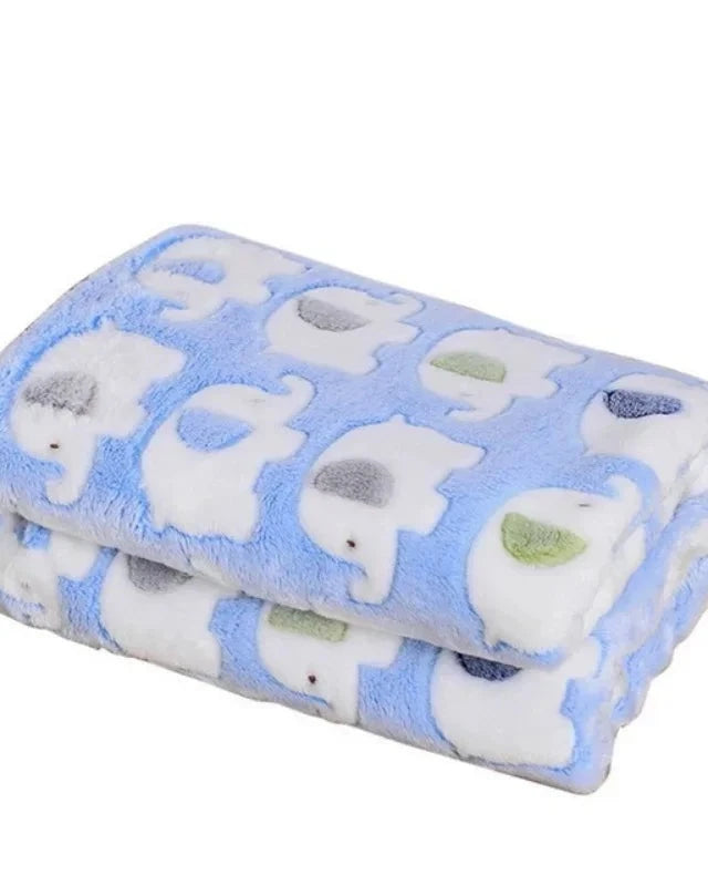 The Sunday Blanket in blue with elephant print, folded, on a white background