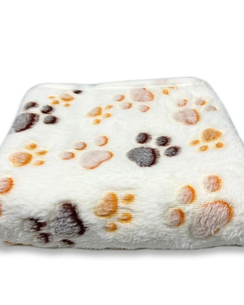 The Sunday Blanket in cream with paw print, folded, on a white background