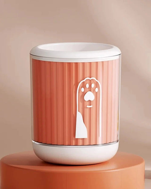 The Dalewood Paw Cleaner in orange on a terracotta plinth