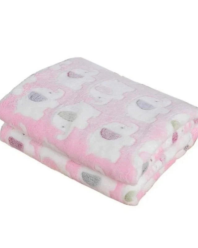 The Sunday Blanket in pale pink with elephant print, folded, on a white background