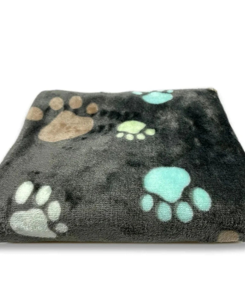 The Sunday Blanket in charcoal with paw print, folded, on a white background