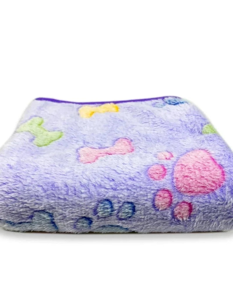The Sunday Blanket in lilac with paw print, folded, on a white background