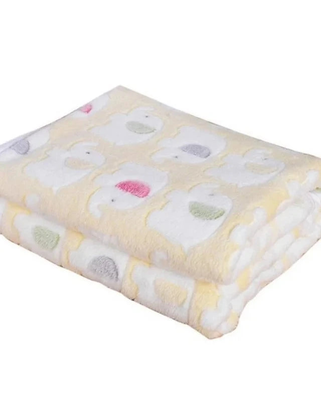 The Sunday Blanket in pale yellow with elephant print, folded, on a white background