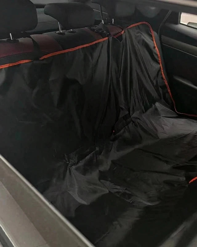 The Back Seat Cover with orange trim fitted as a hammock across a car's back seat
