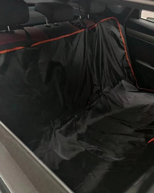 The Back Seat Cover with orange trim fitted as a hammock across a car's back seat