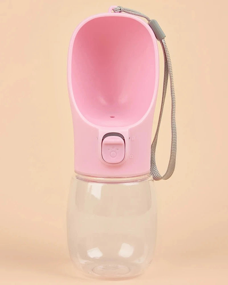 The Long Walk Water Bottle in pink with wrist strap on a cream background