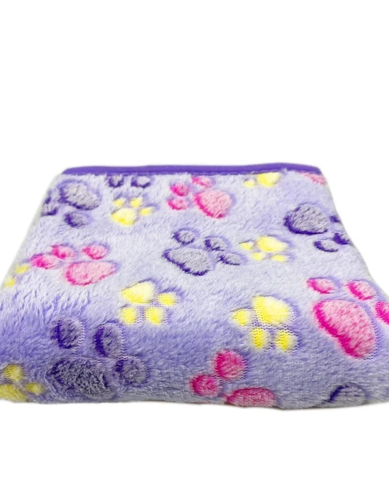 The Sunday Blanket in purple with paw print, folded, on a white background