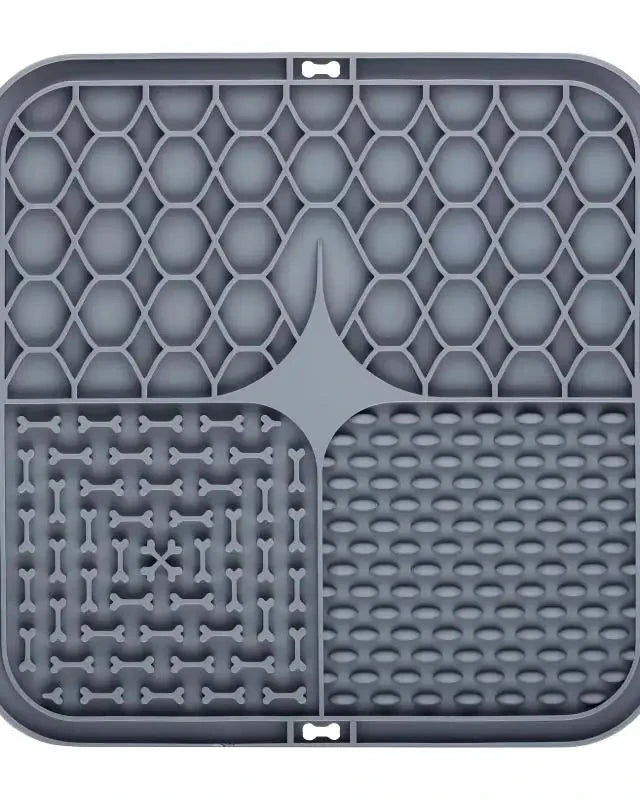 The Slow Sunday Lick Mat in dark grey on a white background