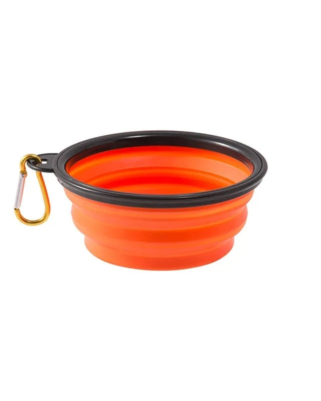 The Fold-Flat Bowl in orange with carabiner on a white background