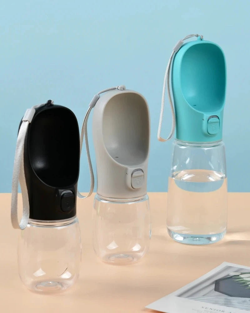 The Long Walk Water Bottle in black, cream and turquoise on a sand-coloured table