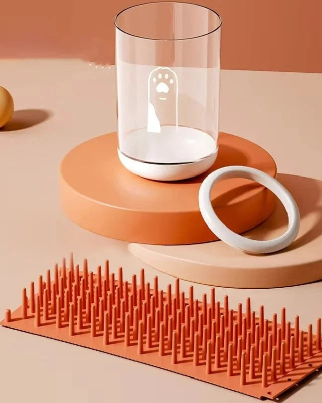 The Dalewood Paw Cleaner in orange taken apart into cup, ring and bristle mat