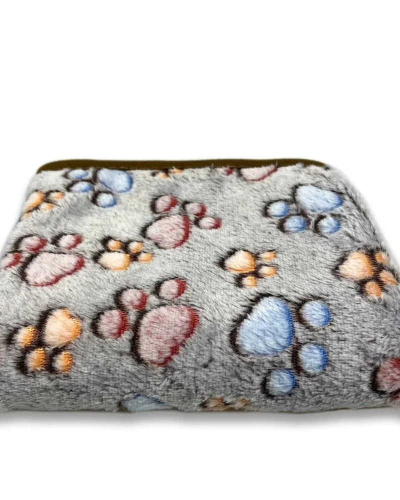 The Sunday Blanket in grey with paw print, folded, on a white background