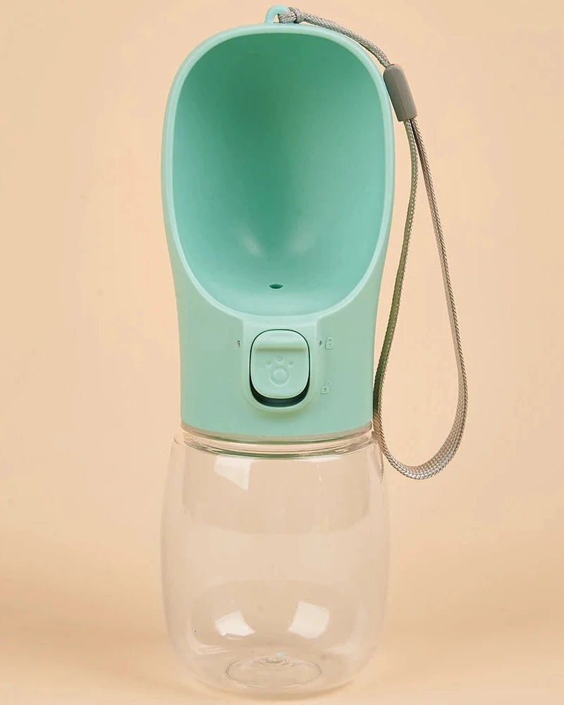 The Long Walk Water Bottle in mint green with wrist strap on a cream background