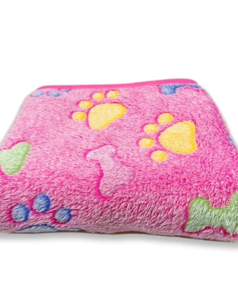 The Sunday Blanket in bright pink with bone print, folded, on a white background