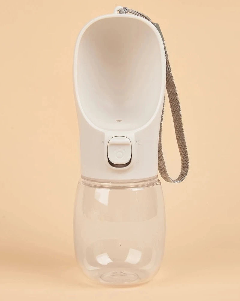 The Long Walk Water Bottle in cream with wrist strap on a cream background