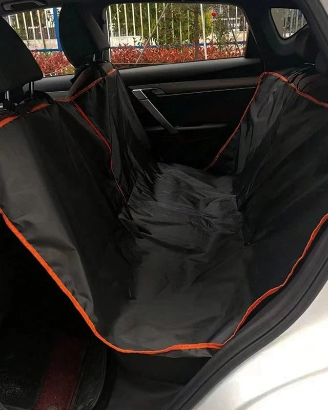 The Back Seat Cover with orange trim fitted in a car, seen from the rear door